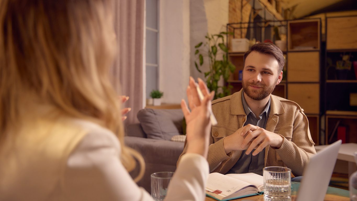 Man listening carefully to mental coach during ACT Therapy